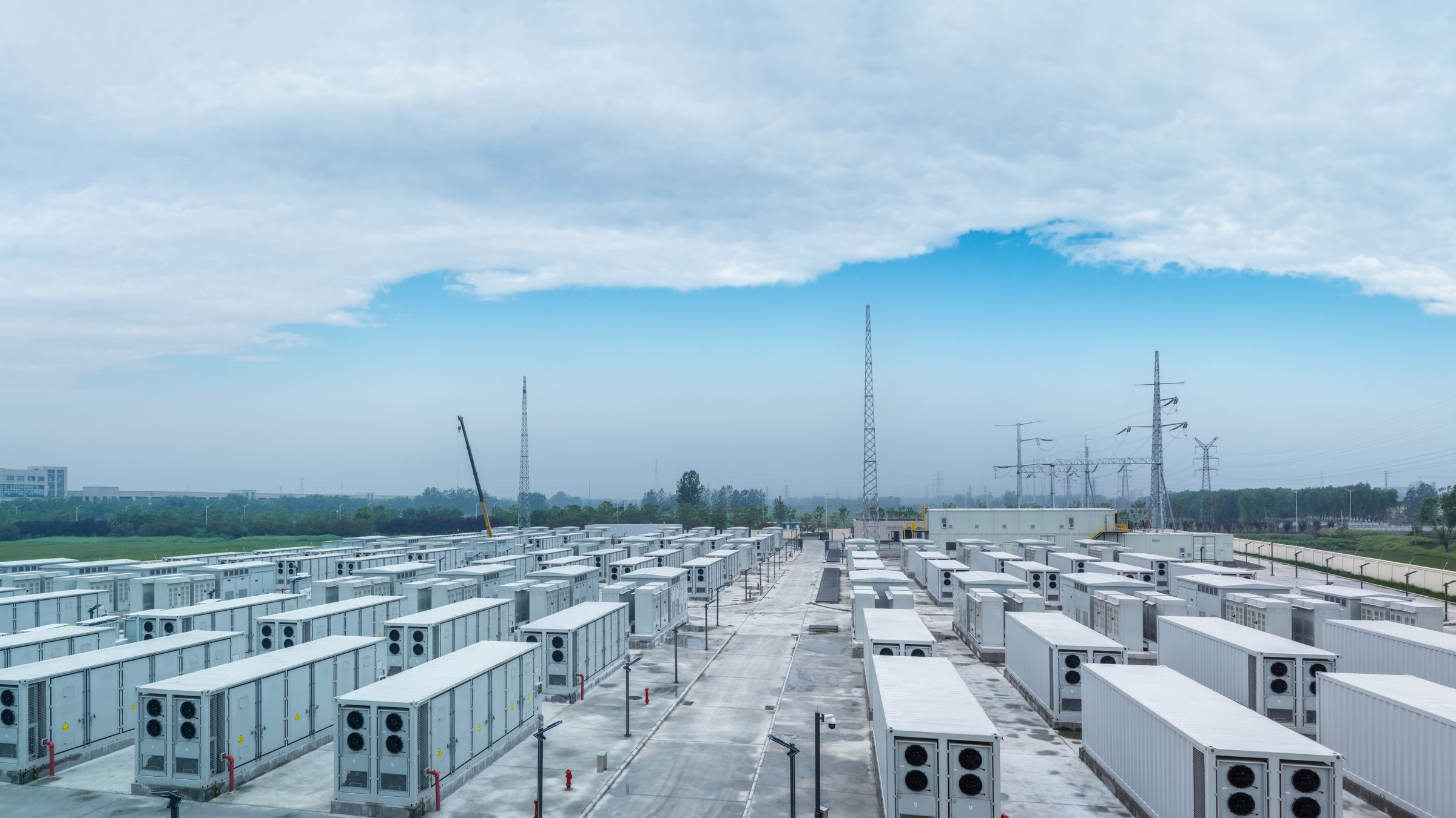 Rows of battery containers at a grid-scale energy storage site