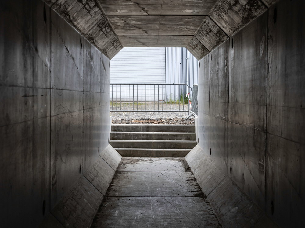 Inside a precast box culvert underpass looking towards the opening